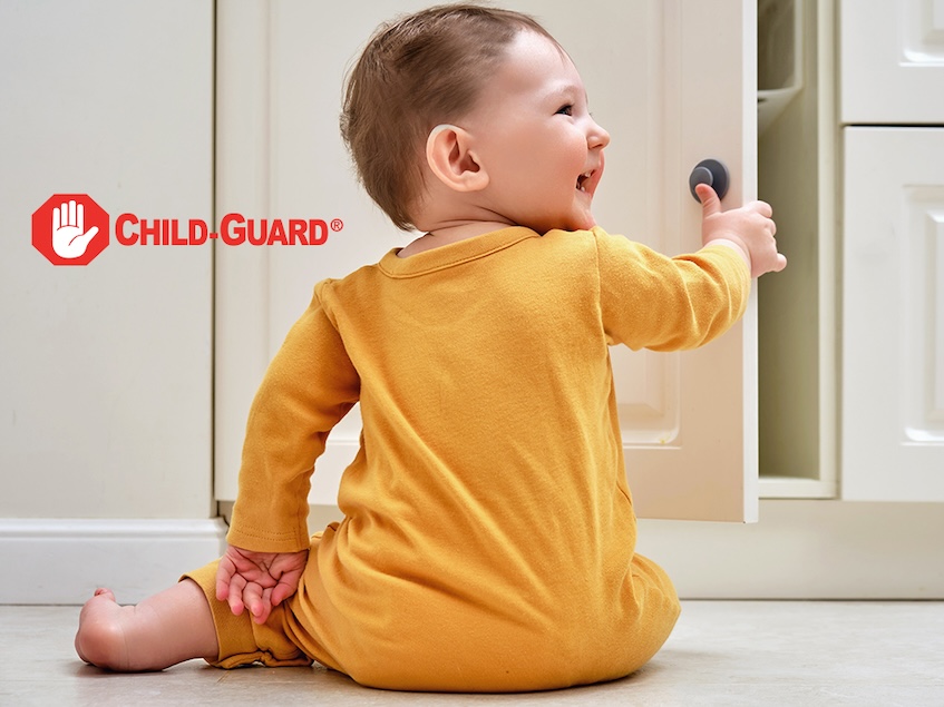 a baby opening a cabinet